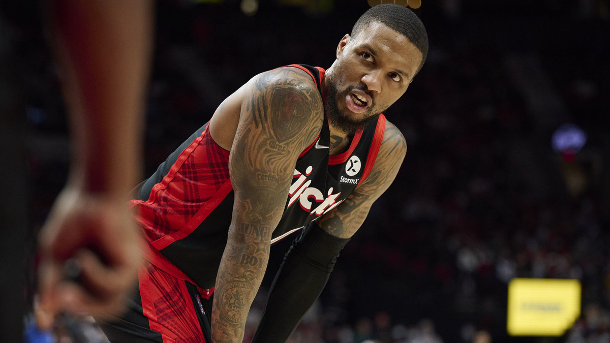 Portland Trail Blazers guard Damian Lillard talks to a referee during the second half against the Philadelphia 76ers at Moda Center.
